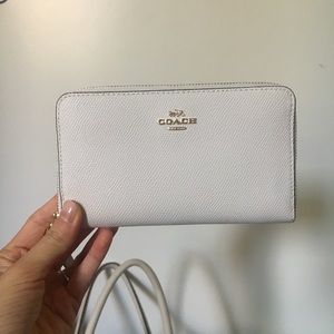 White and gold Coach wristlet / wallet phone case